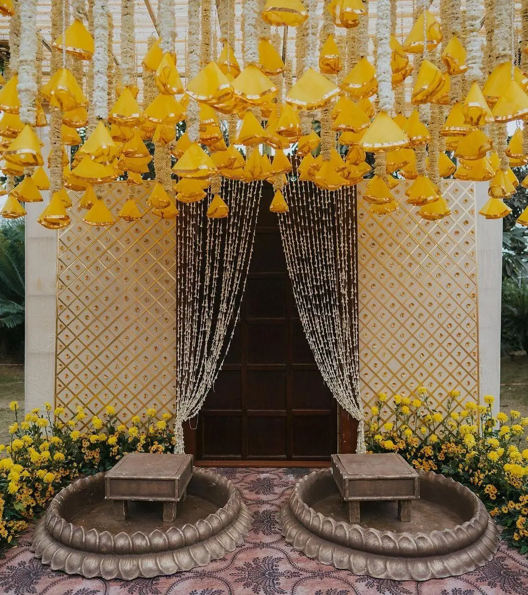 Marigold and drape backdrop at a haldi function