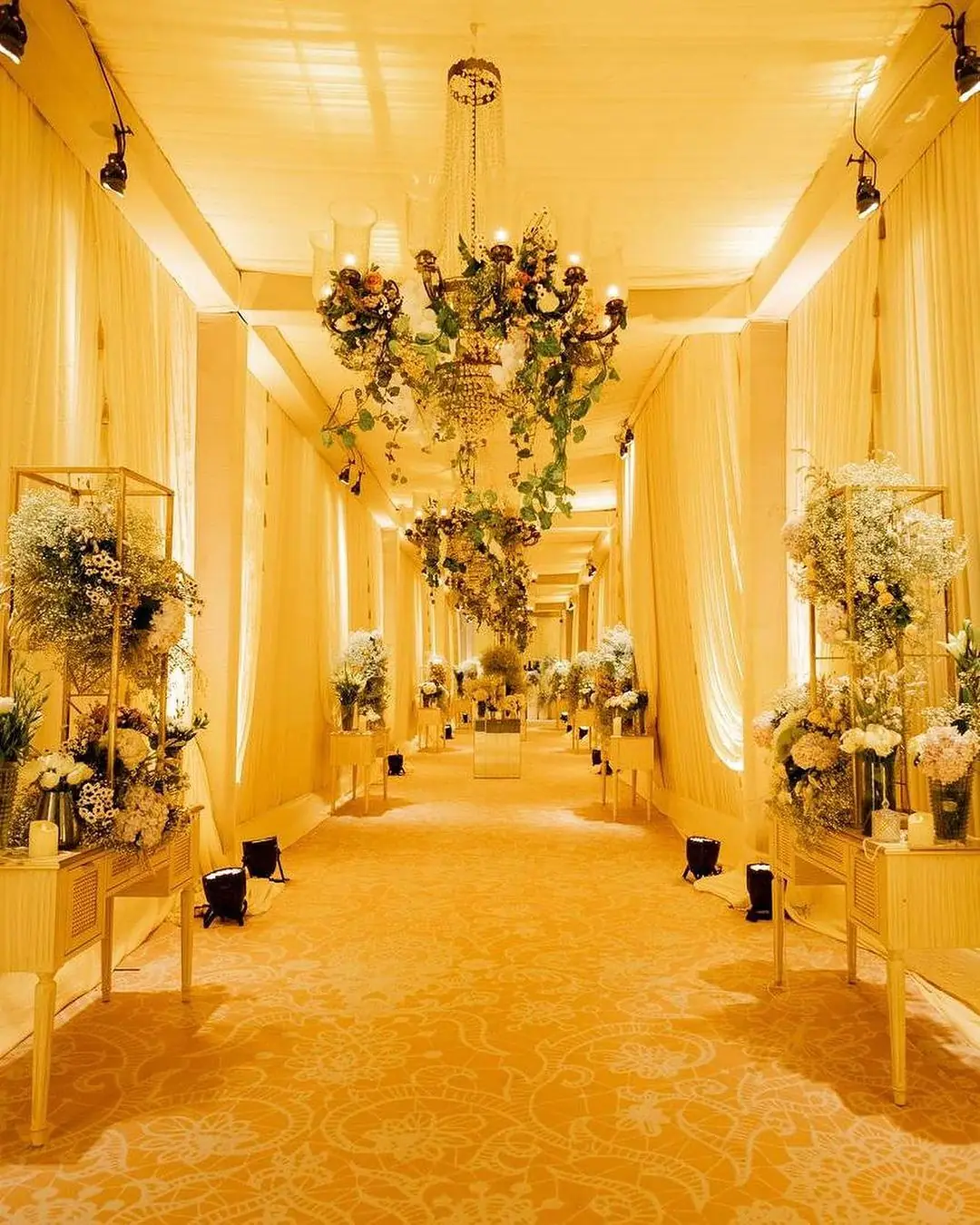 Draped walkway with floral stands
