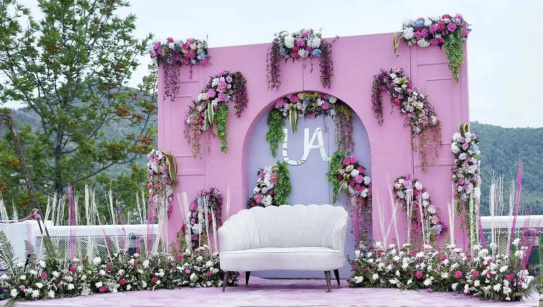 Pastel floral arch built outdoors for a wedding