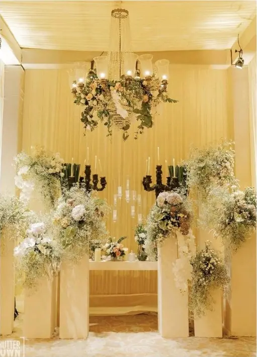 Floral and candle stage set for a ceremony