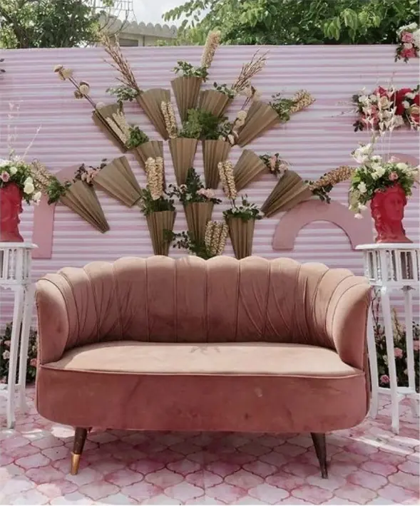 Velvet sofa against a floral photo backdrop