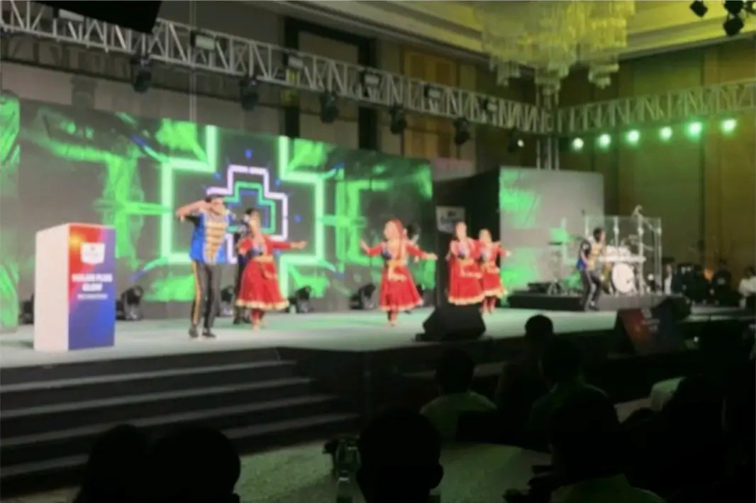 Dance troupe performing on a lit stage