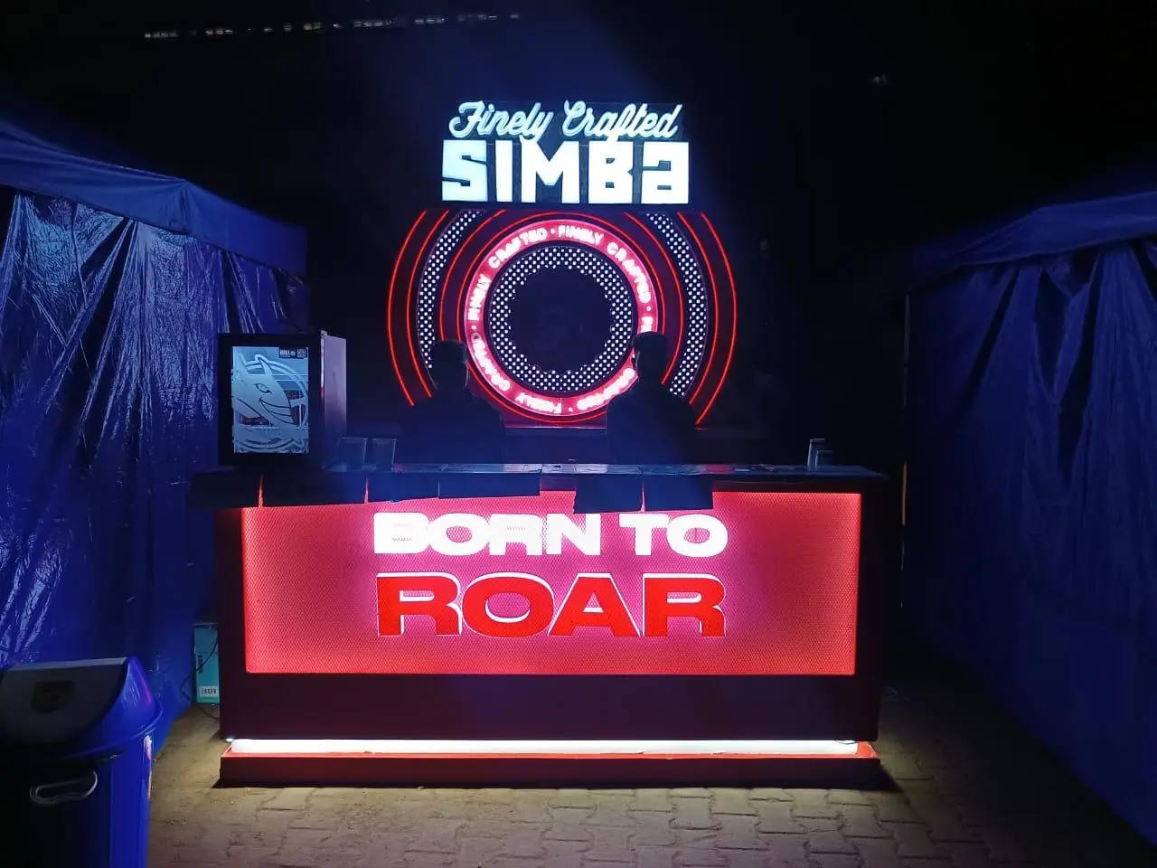 Lit brand signage on a product launch stall